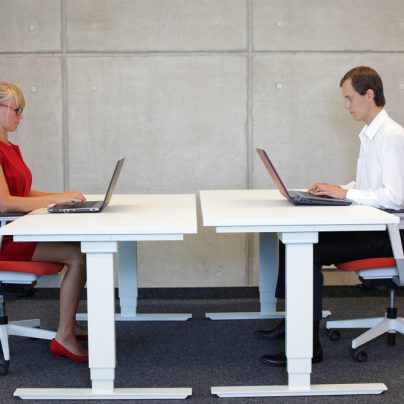 man and lady sitting at desks